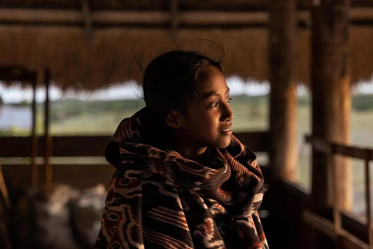 Audi, one of the children who play a vital role in the creation of Sumbanese textiles. After school, they often help older women in weaving houses, assisting them with the making of dye, fetching tools and water, and using the time to learn the craft. 