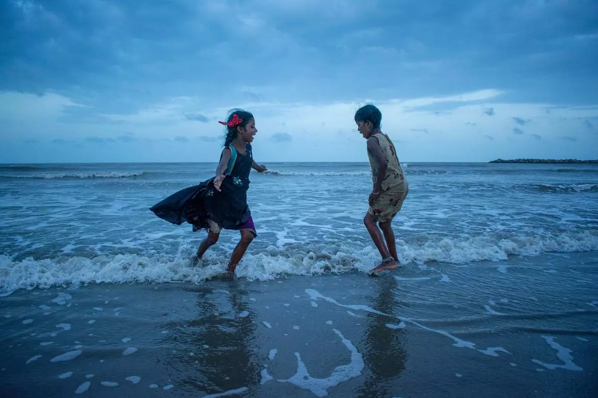 Children in the fishing community often grow up playing on the shores of the beach. Suganthi captures the joy of two young girls chasing after each other.