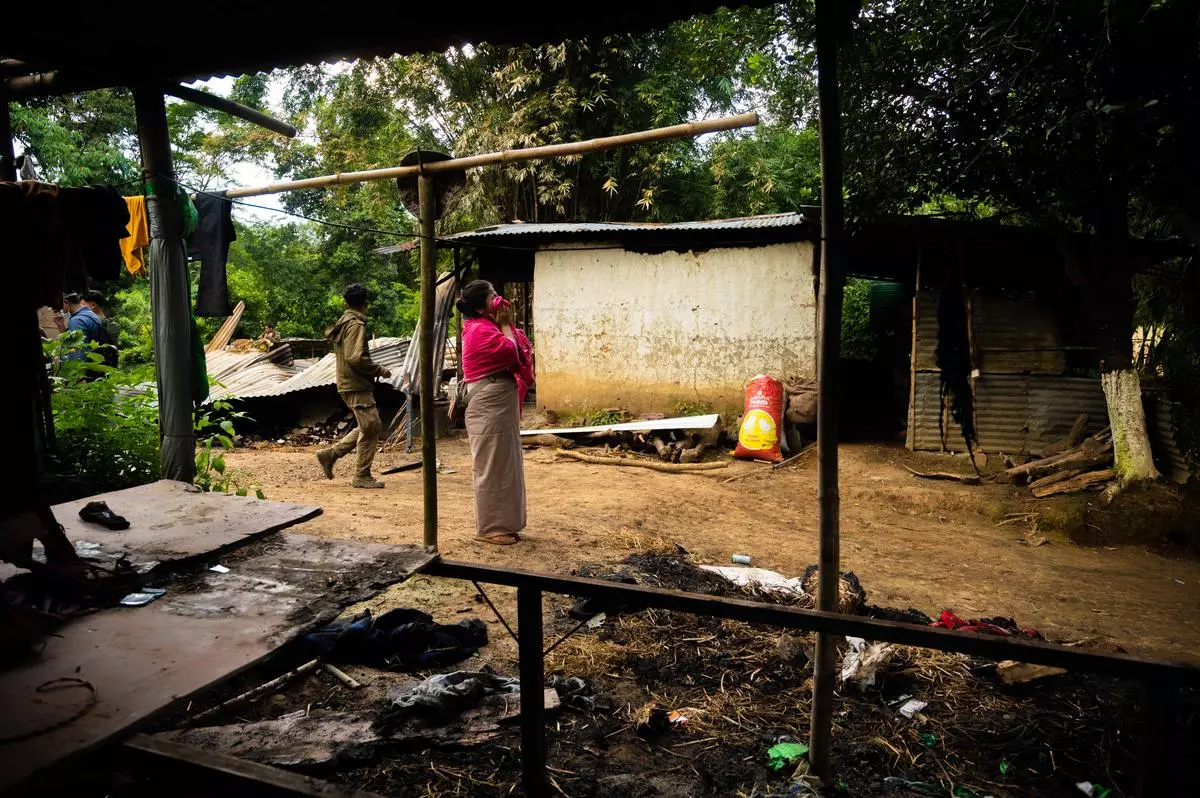 Thangjam Nungshitombi stares at the compound which was once her home. 